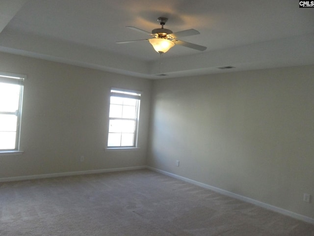 empty room featuring visible vents, baseboards, carpet floors, and ceiling fan