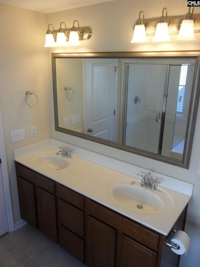 bathroom featuring a sink, double vanity, and tile patterned flooring