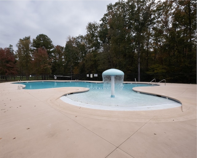 pool featuring a patio area and fence