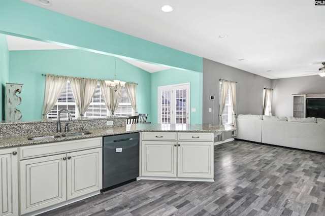 kitchen featuring light stone countertops, open floor plan, dishwasher, ceiling fan with notable chandelier, and a sink