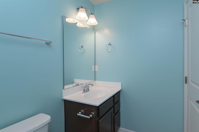 half bathroom with vanity and toilet