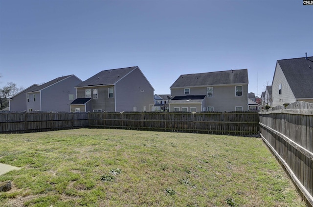 view of yard with a fenced backyard and a residential view