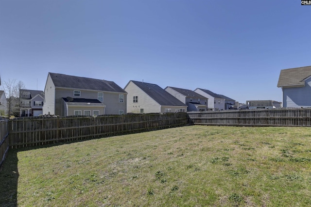 view of yard with a fenced backyard and a residential view