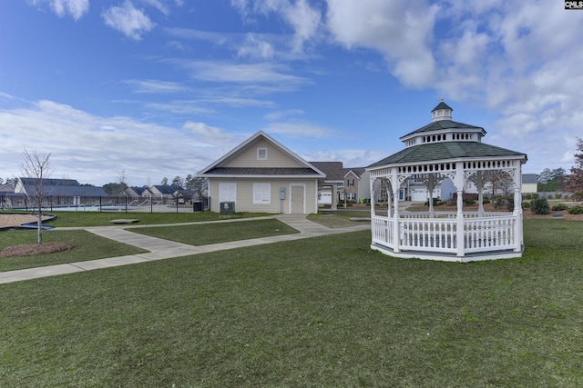 surrounding community with a gazebo, a lawn, and fence