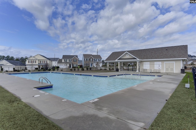 pool featuring a patio area, a residential view, and fence