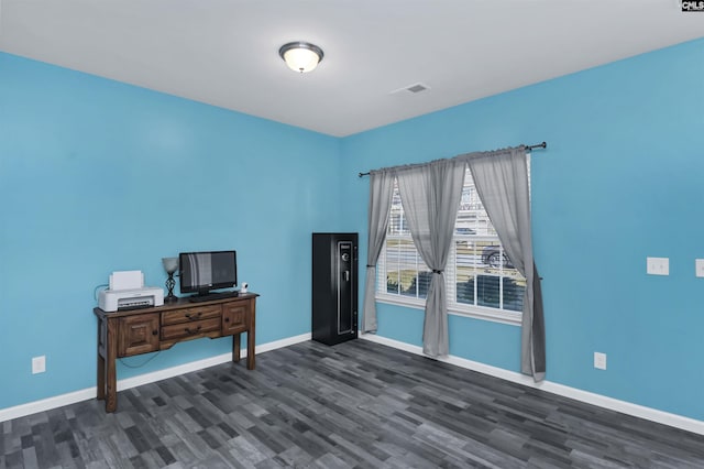 interior space with dark wood-style floors, visible vents, and baseboards