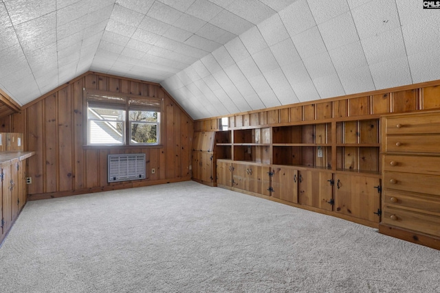 bonus room with lofted ceiling, wooden walls, heating unit, and carpet