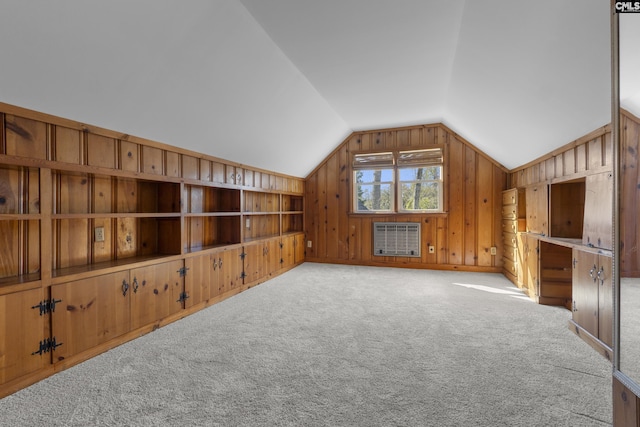 bonus room with heating unit, wooden walls, carpet, and vaulted ceiling