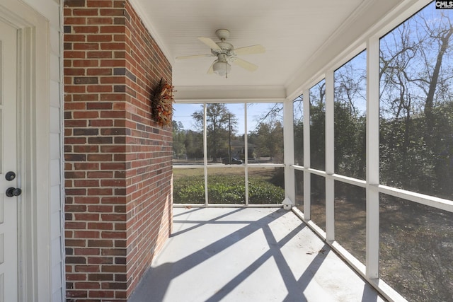 unfurnished sunroom with a ceiling fan