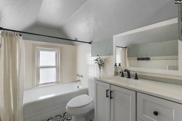 bathroom featuring lofted ceiling, toilet, vanity, and shower / tub combo