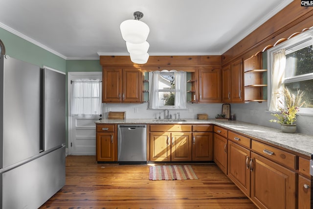 kitchen with open shelves, brown cabinets, appliances with stainless steel finishes, light wood-style flooring, and a sink