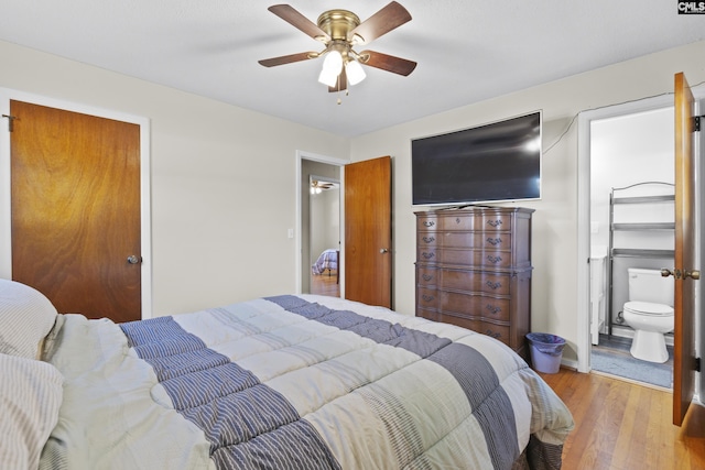 bedroom with ensuite bath, baseboards, a ceiling fan, and wood finished floors