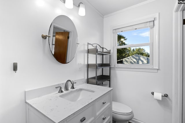 bathroom featuring toilet, ornamental molding, and vanity