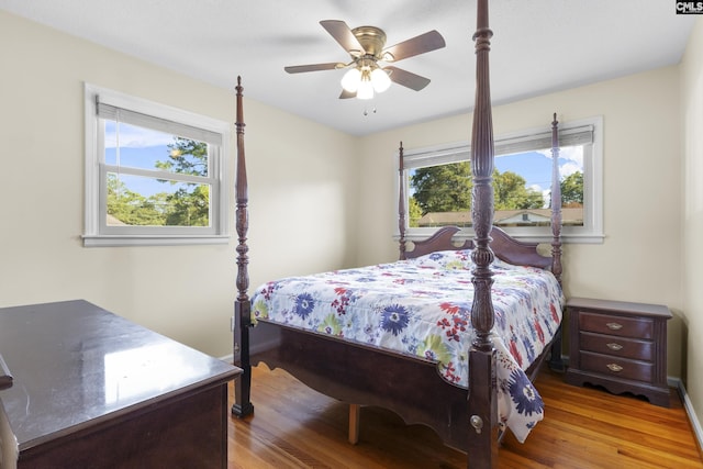 bedroom with a ceiling fan and wood finished floors