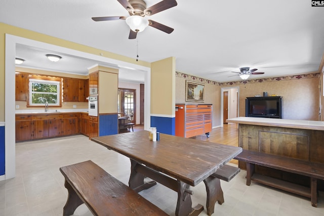 dining area with wallpapered walls, a healthy amount of sunlight, and light floors