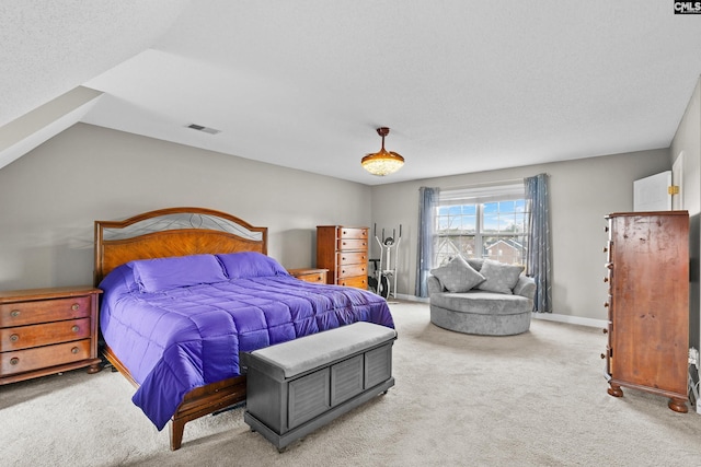 carpeted bedroom featuring lofted ceiling, baseboards, visible vents, and a textured ceiling