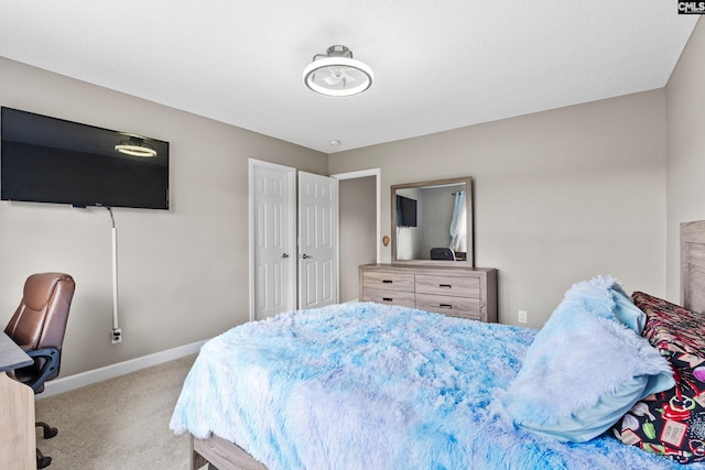 bedroom with baseboards and carpet