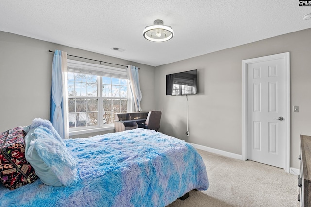 carpeted bedroom featuring baseboards, visible vents, and a textured ceiling