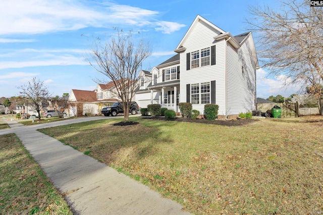 view of front of home with a front lawn, fence, and driveway