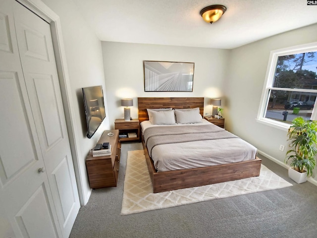 carpeted bedroom featuring baseboards