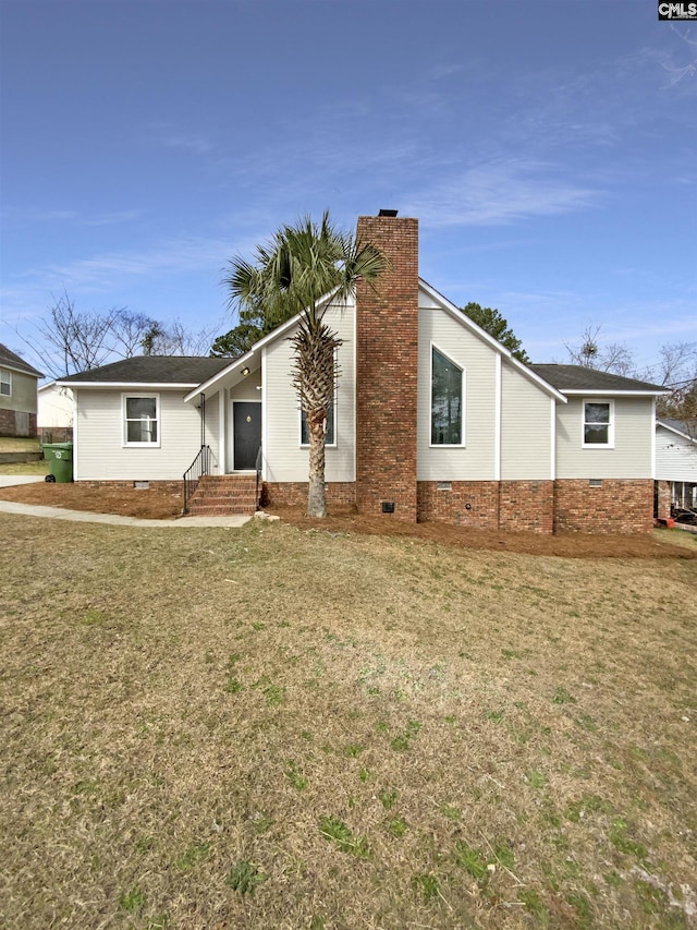 view of front of house featuring crawl space, a chimney, and a front lawn