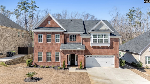 view of front facade with concrete driveway, an attached garage, brick siding, and a shingled roof