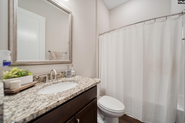 bathroom featuring shower / bath combination with curtain, toilet, vanity, and wood finished floors