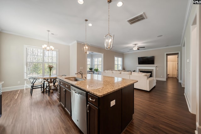 kitchen featuring visible vents, a fireplace, a sink, dark brown cabinets, and stainless steel dishwasher