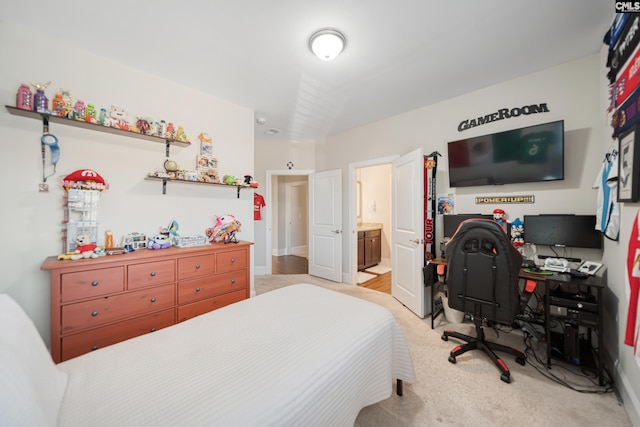 bedroom featuring light colored carpet and connected bathroom