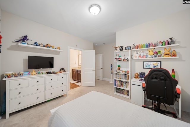 bedroom featuring light colored carpet and connected bathroom