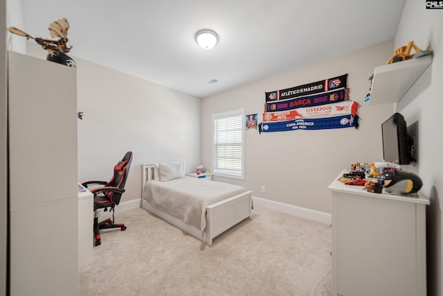 carpeted bedroom featuring visible vents and baseboards