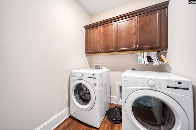 laundry area with baseboards, cabinet space, dark wood-style floors, and washing machine and clothes dryer