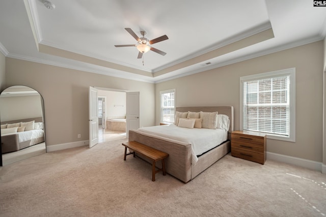 bedroom featuring a raised ceiling, baseboards, and light carpet