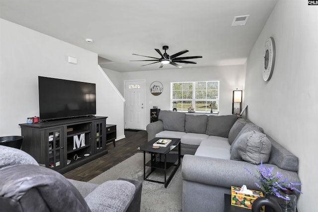 living area with wood finished floors, visible vents, and ceiling fan