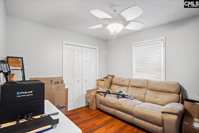 office featuring a textured ceiling, ceiling fan, and wood finished floors