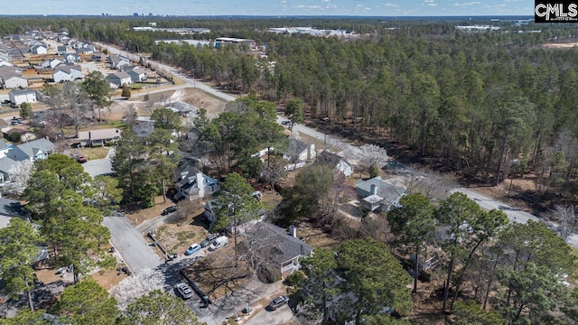 drone / aerial view featuring a forest view and a residential view