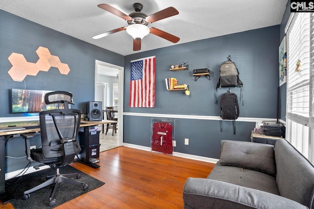 office area with ceiling fan, baseboards, and wood finished floors