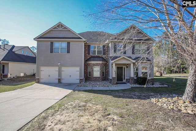 craftsman house with a garage, concrete driveway, and a front yard