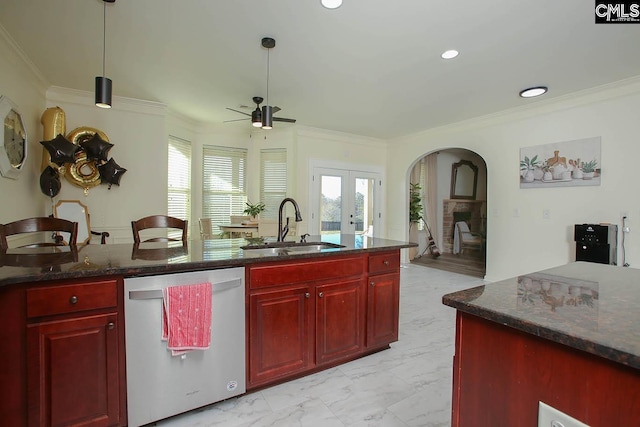 kitchen with dark brown cabinets, marble finish floor, dishwasher, and a sink