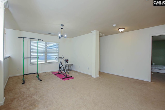 exercise room with light carpet, visible vents, baseboards, and ornate columns