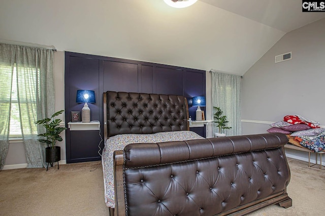 bedroom with light carpet, visible vents, baseboards, and vaulted ceiling