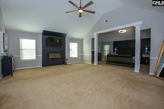 unfurnished living room featuring a ceiling fan, visible vents, ornate columns, a fireplace, and light colored carpet