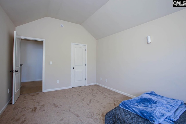 bedroom with baseboards, carpet, and vaulted ceiling