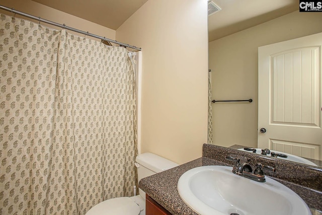 bathroom with a shower with shower curtain, visible vents, toilet, and vanity