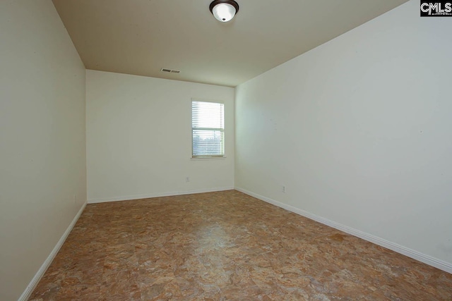 unfurnished room featuring visible vents and baseboards