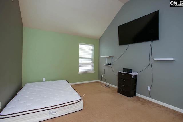 carpeted bedroom with baseboards and vaulted ceiling