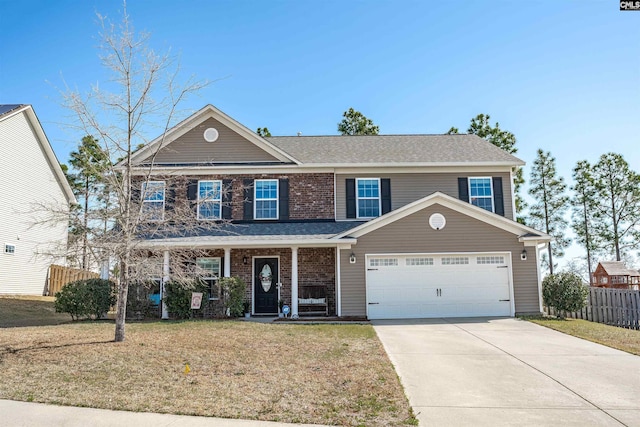 traditional home with fence, a porch, concrete driveway, a front yard, and a garage