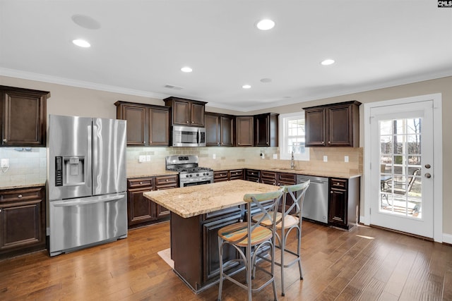 kitchen with dark brown cabinetry, appliances with stainless steel finishes, and a sink