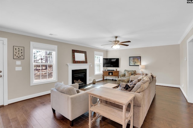 living room with visible vents, baseboards, dark wood-style flooring, and crown molding