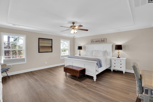 bedroom with ceiling fan, dark wood-type flooring, baseboards, and ornamental molding